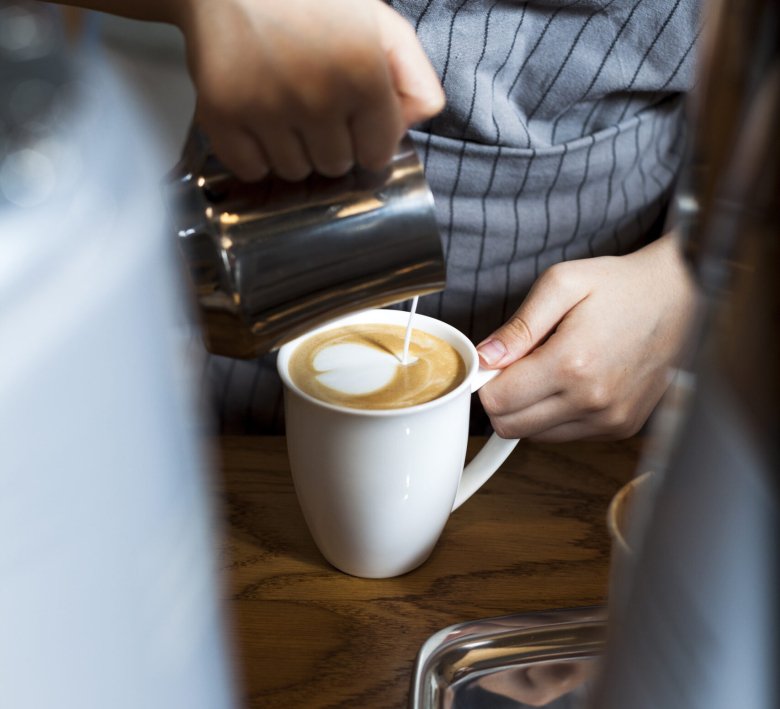 professional-barista-pouring-latte-foam-coffee-caf